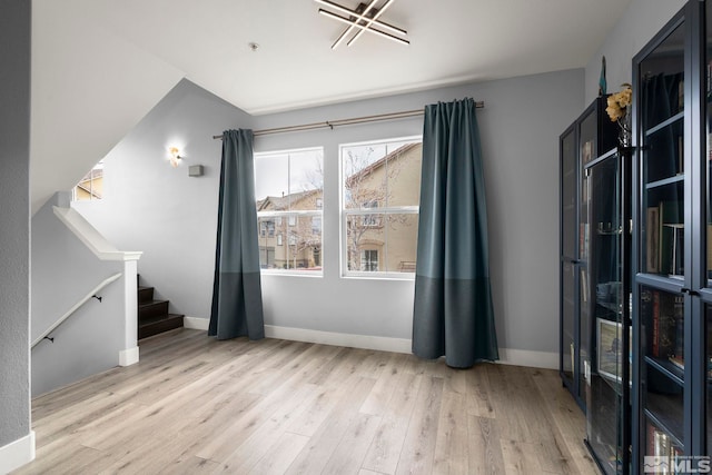 17000 Wedge Pkwy Unit 3221, Reno, NV 89511 - unfurnished living room with wood finished floors, stairs, and baseboards