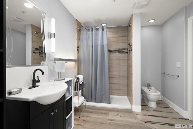 17000 Wedge Pkwy Unit 3221, Reno, NV 89511 - bathroom featuring a shower stall, wood finished floors, vanity, a bidet, and recessed lighting