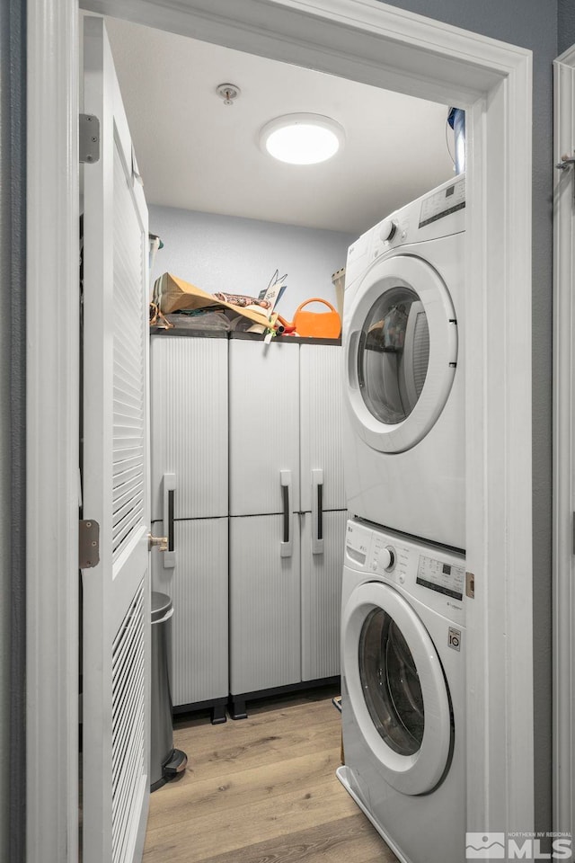 17000 Wedge Pkwy Unit 3221, Reno, NV 89511 - clothes washing area featuring stacked washer and clothes dryer and wood finished floors