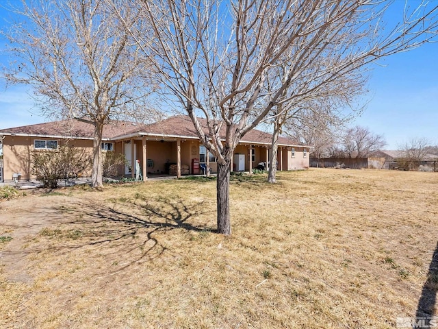 4259 Rancheria Rd, Fallon, NV 89406 - ranch-style home featuring stucco siding and a front lawn