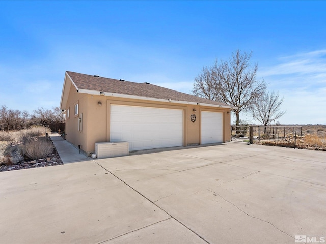 4259 Rancheria Rd, Fallon, NV 89406 - view of side of home featuring stucco siding and a garage