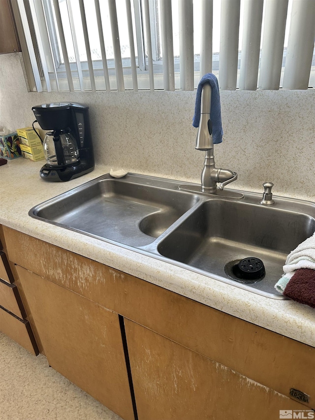 101 Mcculloch Ave, Tonopah, NV 89049 - kitchen view of a sink, light countertops, tasteful backsplash, and brown cabinetry