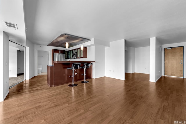 255 N Sierra St Unit 815, Reno, NV 89501 - living area with dark wood finished floors, bar, and baseboards