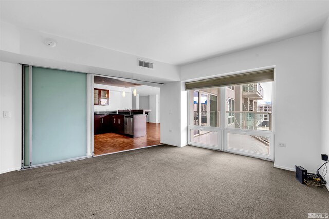 255 N Sierra St Unit 815, Reno, NV 89501 - unfurnished living room featuring carpet floors and a sink