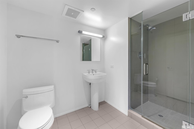 255 N Sierra St Unit 815, Reno, NV 89501 - full bathroom featuring toilet, a stall shower, tile patterned floors, baseboards, and a sink