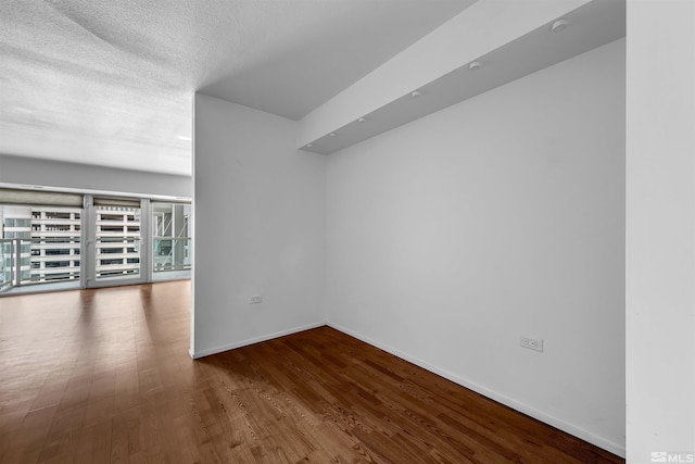 255 N Sierra St Unit 815, Reno, NV 89501 - empty room featuring wood finished floors, baseboards, and a textured ceiling