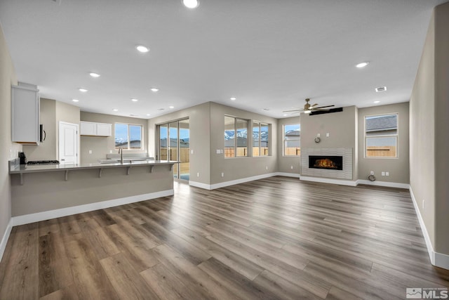 21 Nova Ct Unit 111, Carson City, NV 89705 - unfurnished living room with ceiling fan, baseboards, recessed lighting, and dark wood finished floors