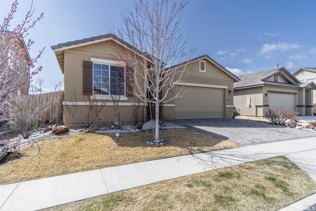 7117 Mustengo Dr, Reno, NV 89506 - view of front facade with decorative driveway, stucco siding, and a garage