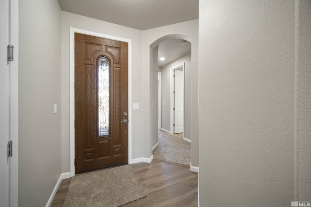 7117 Mustengo Dr, Reno, NV 89506 - foyer featuring arched walkways, baseboards, and wood finished floors