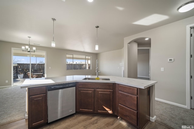 7117 Mustengo Dr, Reno, NV 89506 - kitchen featuring a sink, dishwasher, light countertops, arched walkways, and dark brown cabinets