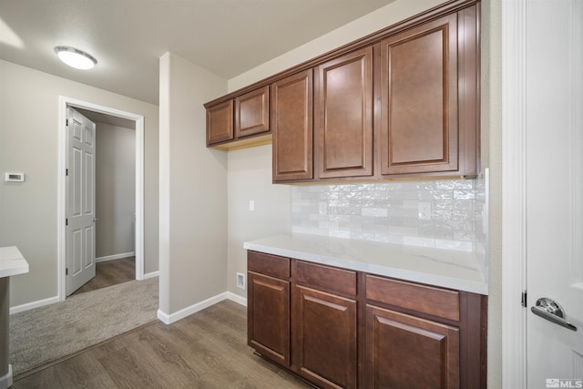 7117 Mustengo Dr, Reno, NV 89506 - kitchen with dark wood-type flooring, decorative backsplash, and baseboards