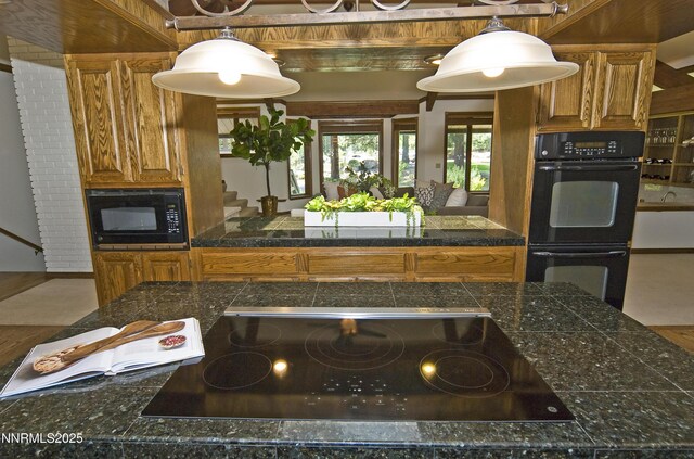 205 Scotch Pine Rd, Reno, NV 89511 - kitchen with black appliances, tile countertops, brown cabinets, and decorative light fixtures