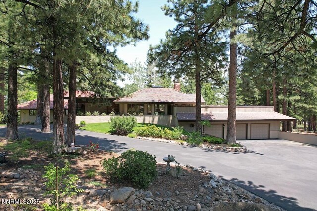 205 Scotch Pine Rd, Reno, NV 89511 - view of front of property with a garage, driveway, and a chimney