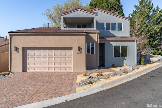2665 Rockview Dr, Reno, NV 89519 - view of front of property with stucco siding, decorative driveway, a tiled roof, and an attached garage