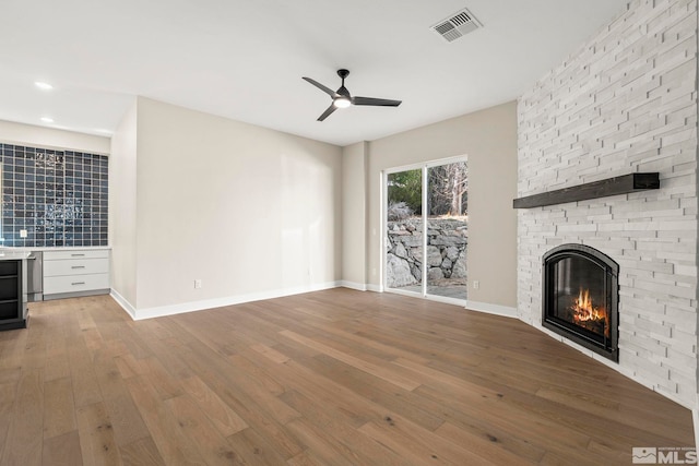 2665 Rockview Dr, Reno, NV 89519 - unfurnished living room with hardwood / wood-style flooring, a ceiling fan, a fireplace, bar area, and baseboards
