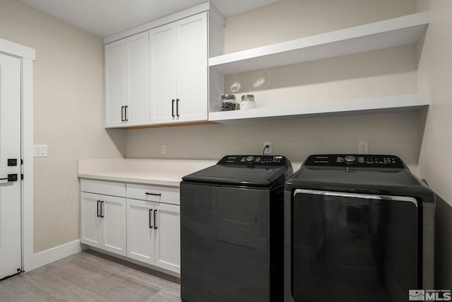 2665 Rockview Dr, Reno, NV 89519 - laundry room featuring washer and clothes dryer, light wood finished floors, cabinet space, and baseboards
