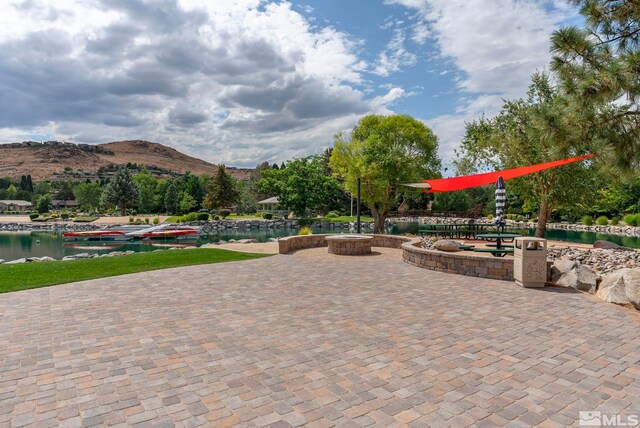2665 Rockview Dr, Reno, NV 89519 - view of patio with a water and mountain view and a fire pit