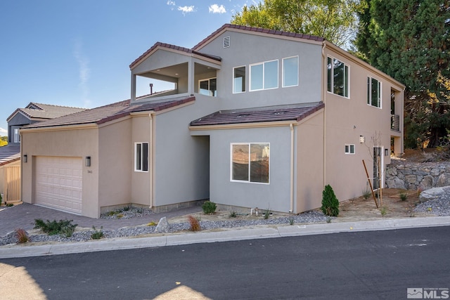 2665 Rockview Dr, Reno, NV 89519 - view of front facade featuring a garage, a tiled roof, driveway, and stucco siding