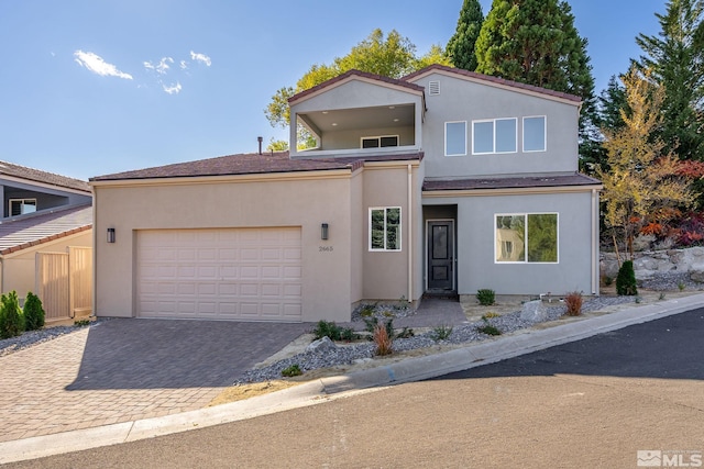 2665 Rockview Dr, Reno, NV 89519 - view of front facade featuring a garage, driveway, and stucco siding