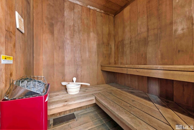sauna / steam room with wood walls