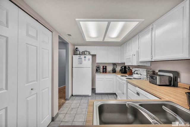 785 Kingston Ln Unit E, Reno, NV 89511 - kitchen with white appliances, a sink, light tile patterned floors, and white cabinetry