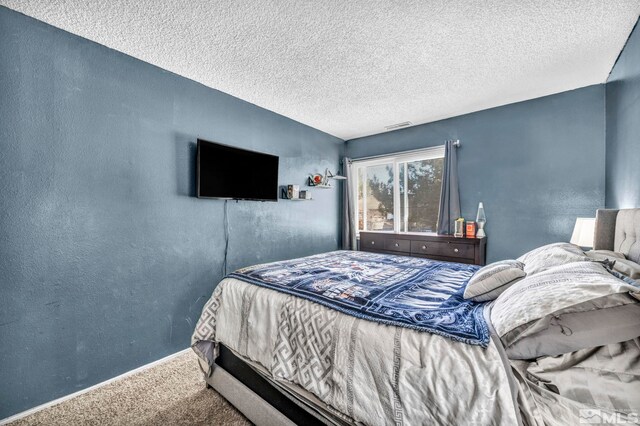 785 Kingston Ln Unit E, Reno, NV 89511 - carpeted bedroom featuring a textured ceiling, a textured wall, and baseboards