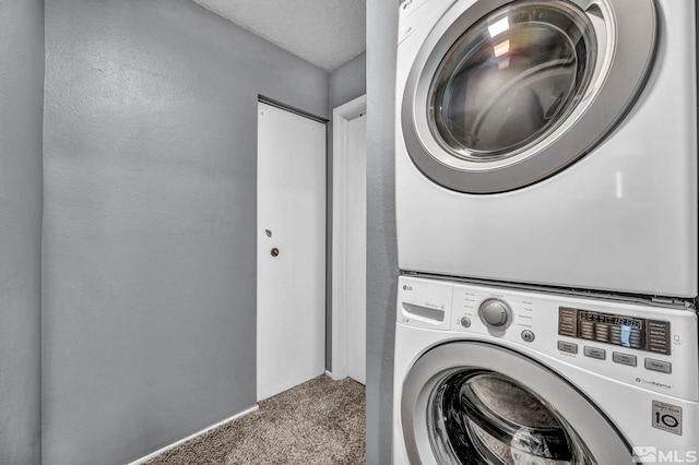 785 Kingston Ln Unit E, Reno, NV 89511 - washroom featuring stacked washer / drying machine and carpet
