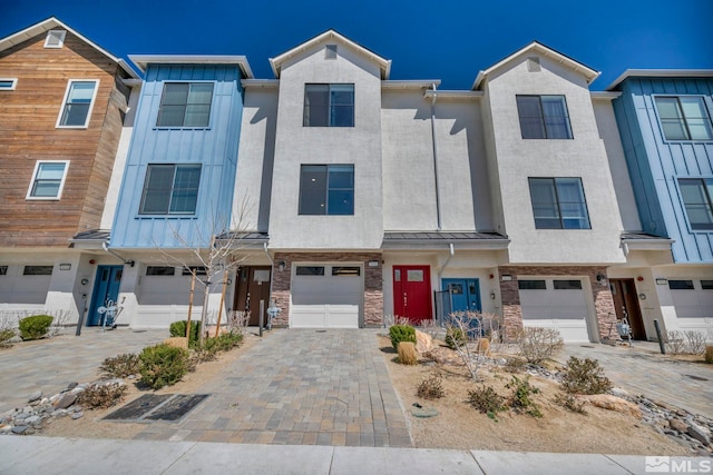 5030 Ronald Stephen Cir, Reno, NV 89503 - view of property with an attached garage, stone siding, and a standing seam roof