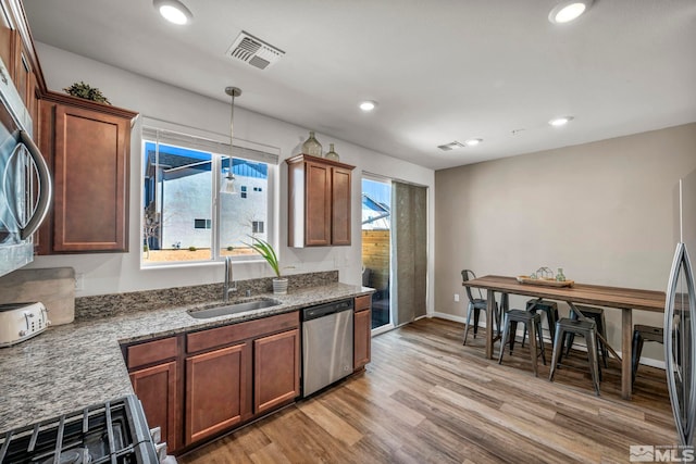 5030 Ronald Stephen Cir, Reno, NV 89503 - kitchen featuring a sink, appliances with stainless steel finishes, stone countertops, light wood finished floors, and recessed lighting