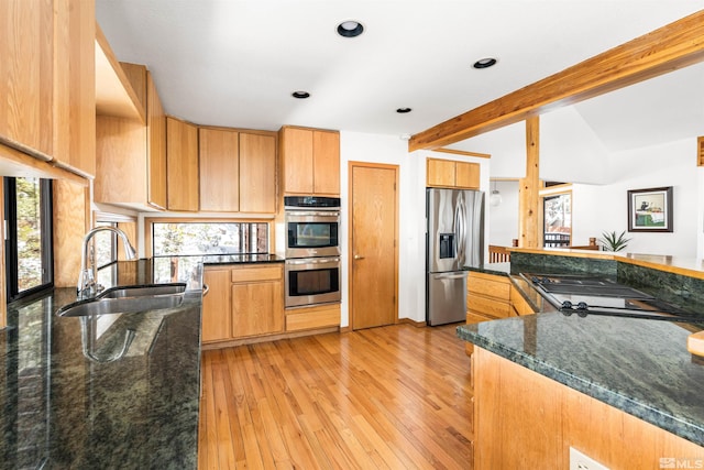 513 Lucille Dr, Incline Village, NV 89451 - kitchen featuring stainless steel appliances, a sink, dark stone counters, light wood-type flooring, and recessed lighting