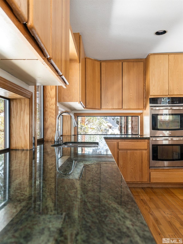 513 Lucille Dr, Incline Village, NV 89451 - kitchen featuring stainless steel double oven, a sink, and wood finished floors