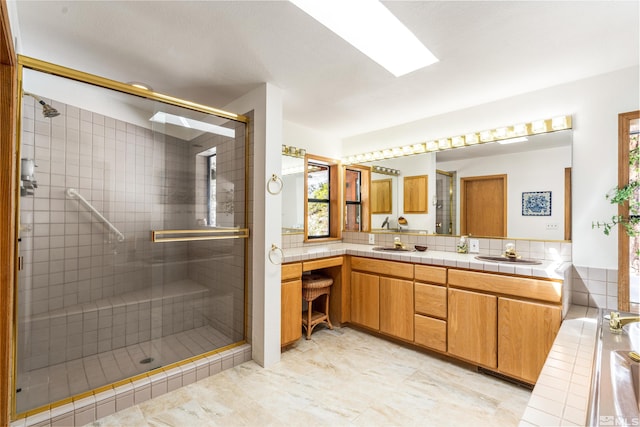 513 Lucille Dr, Incline Village, NV 89451 - bathroom with double vanity, a shower stall, and a skylight