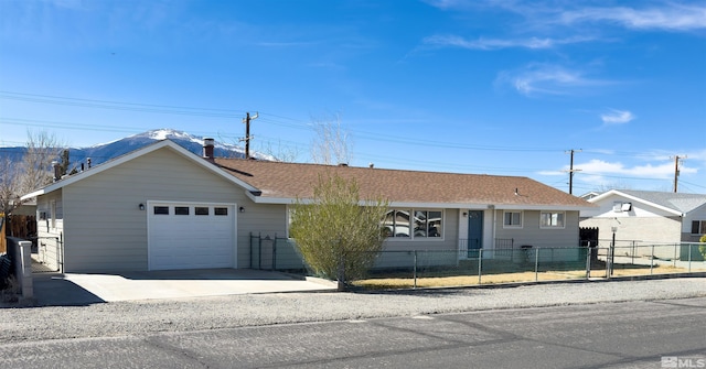 675 L St, Hawthorne, NV 89415 - ranch-style house with driveway, a fenced front yard, and roof with shingles