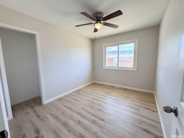 675 L St, Hawthorne, NV 89415 - empty room featuring a ceiling fan, light wood finished floors, and baseboards