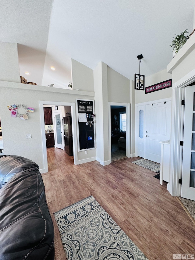 629 Ross St, Winnemucca, NV 89445 - living room with wood finished floors, baseboards, recessed lighting, and high vaulted ceiling