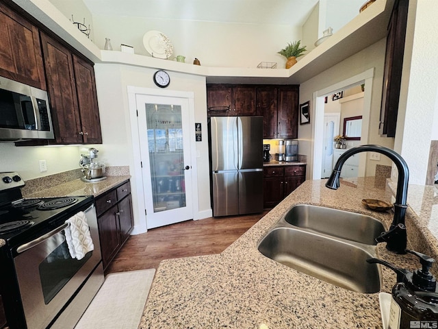 629 Ross St, Winnemucca, NV 89445 - kitchen featuring stainless steel appliances, a sink, light stone countertops, and dark brown cabinets