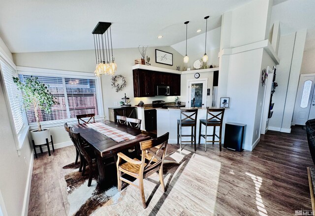 629 Ross St, Winnemucca, NV 89445 - dining area featuring healthy amount of natural light, wood finished floors, baseboards, high vaulted ceiling, and a chandelier