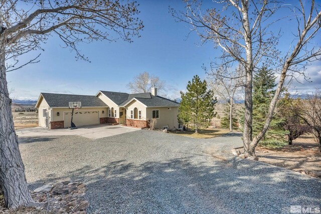 1568 Barker Ct, Gardnerville, NV 89410 - single story home featuring gravel driveway, an attached garage, brick siding, and a chimney