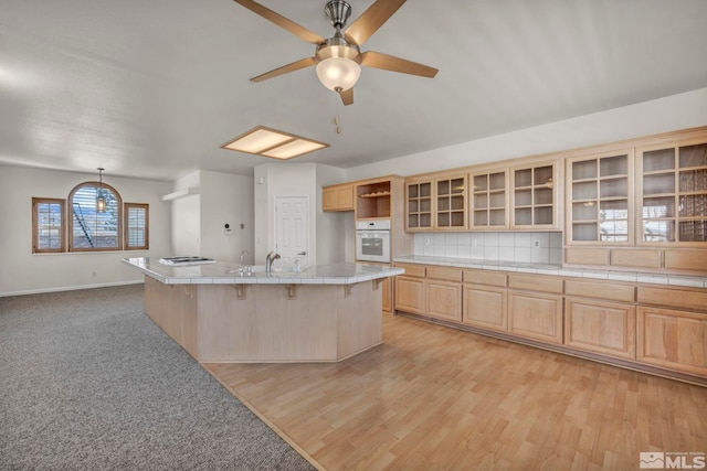 1568 Barker Ct, Gardnerville, NV 89410 - kitchen featuring oven, light brown cabinets, glass insert cabinets, ceiling fan, and baseboards