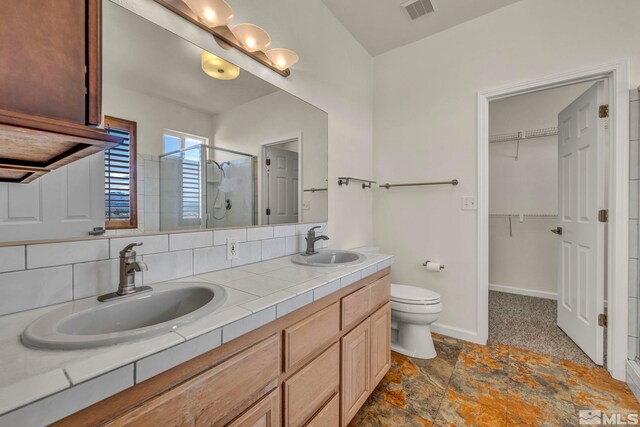 1568 Barker Ct, Gardnerville, NV 89410 - bathroom featuring a stall shower, double vanity, a spacious closet, toilet, and baseboards
