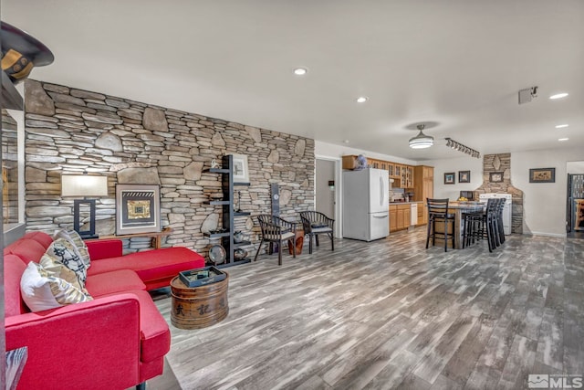1568 Barker Ct, Gardnerville, NV 89410 - living area with a wood stove, wood finished floors, recessed lighting, and baseboards