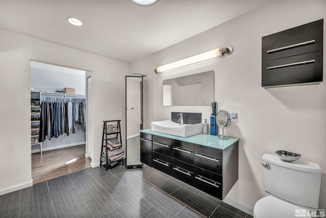 1568 Barker Ct, Gardnerville, NV 89410 - bathroom featuring baseboards, vanity, toilet, and a walk in closet
