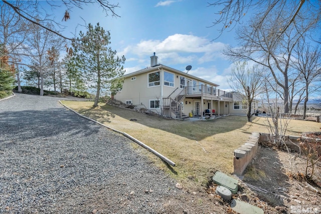 1568 Barker Ct, Gardnerville, NV 89410 - view of home's exterior featuring a wooden deck, a lawn, stairs, and a chimney