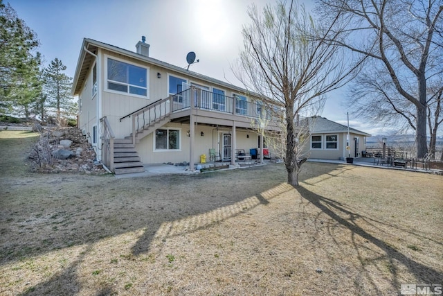 1568 Barker Ct, Gardnerville, NV 89410 - back of house with stairs, a wooden deck, a patio area, and a chimney