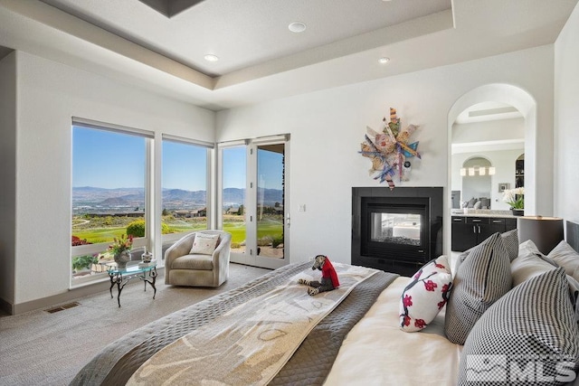4020 Cocopah Ct, Reno, NV 89511 - bedroom with access to exterior, a mountain view, a multi sided fireplace, light colored carpet, and recessed lighting