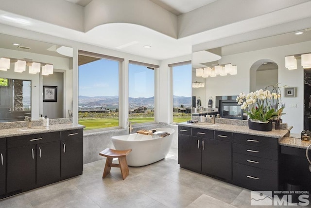 4020 Cocopah Ct, Reno, NV 89511 - bathroom featuring a mountain view, two vanities, and a freestanding tub