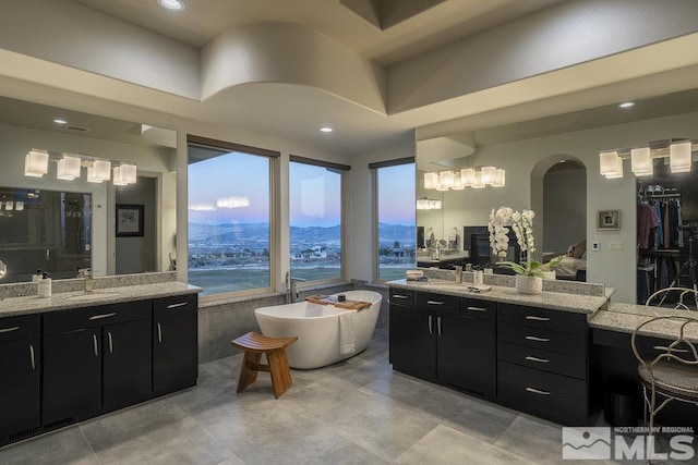 4020 Cocopah Ct, Reno, NV 89511 - bathroom featuring a freestanding bath, two vanities, and recessed lighting