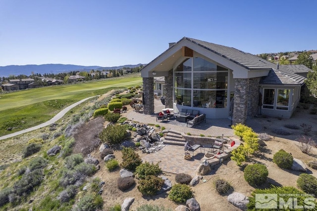 4020 Cocopah Ct, Reno, NV 89511 - back of property with a patio, an outdoor living space with a fire pit, view of golf course, and a mountain view