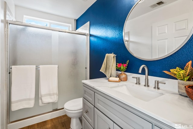 3550 Silverado, Carson City, NV 89705 - bathroom featuring wood finished floors, a shower stall, vanity, and toilet