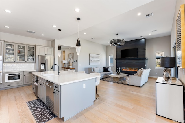 8956 Suncreek Trl, Reno, NV 89523 - kitchen featuring gray cabinetry, stainless steel appliances, light wood-style flooring, light countertops, and recessed lighting